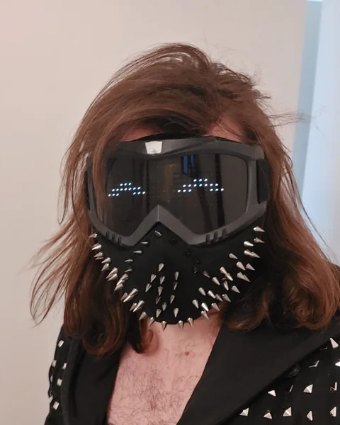 Wr3nch in goggles and a spiked mask with glowing LED eyes